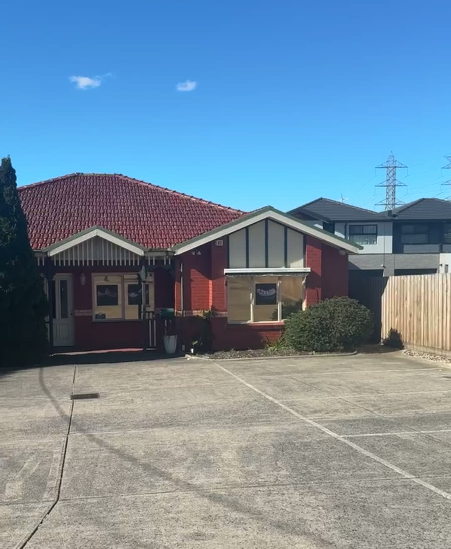 The Supreme Denture Studio building, set back from Plenty Rd with parking in front
