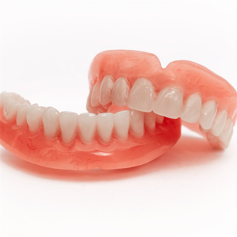 A complete set of upper and lower full dentures